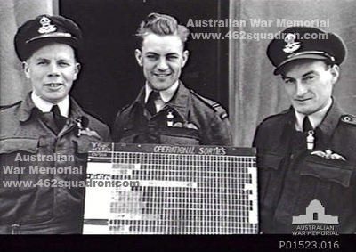 Pilots FO Walter Henry Scott 426982 RAAF, FO William John Frazer 422040 RAAF, and FO Jack Roy Smith 427264 RAAF, with Operational Sorties Board for B Flight, 462 Squadron, Foulsham, June 1945. (AWM photo).