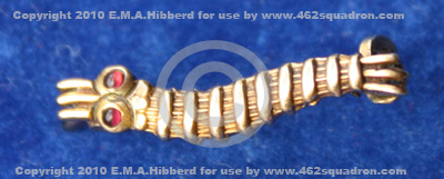 Gold Caterpillar Club pin, top view, showing Ruby eyes, Club Member F/Sgt M.J.Hibberd 435342 RAAF.