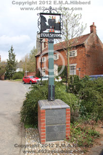 Redesigned and relocated Foulsham Village Sign with two Memorial Plaques as seen in April 2012.