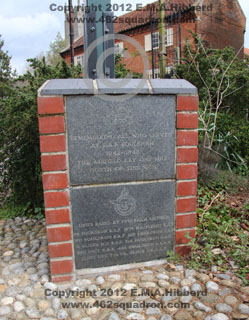 Close-up of plinth of Foulsham Village Sign with two Memorial Plaques as seen in April 2012.