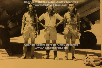 Charles Robert Borden AINLEY, 1451753 RAFVR, at right, and 2 additional Crew members beside an unidentified aircraft, in Libya, undated, WW2.